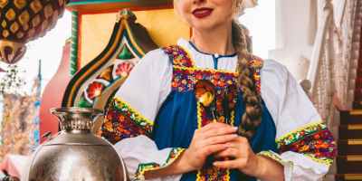 woman in traditional russian costume with samovar