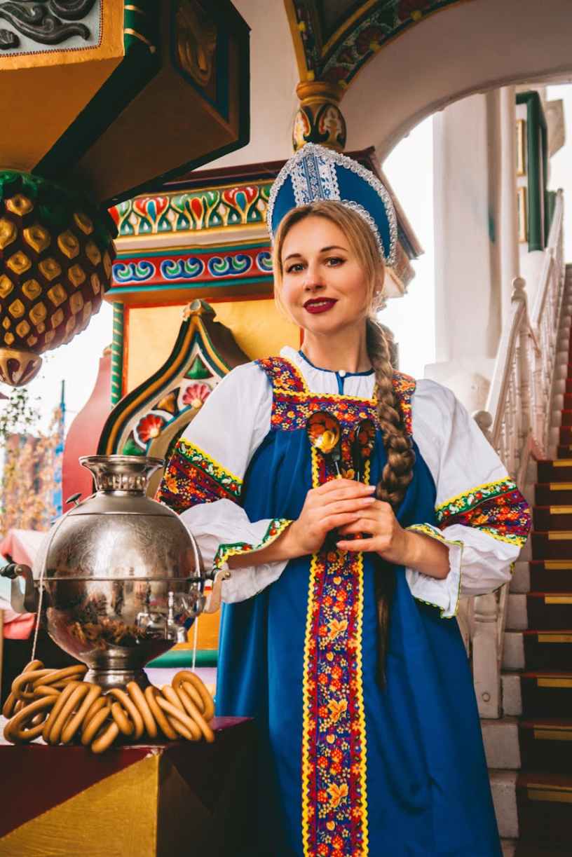 woman in traditional russian costume with samovar