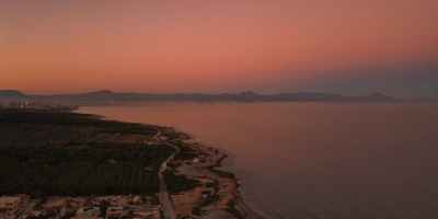 aerial view of a coastline at sunset