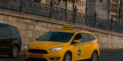 yellow taxi on budapest street with classic architecture