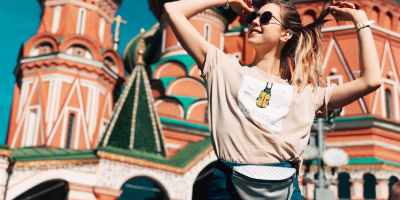 photo of woman dancing with saint basil s cathedral in moscow russia in the background